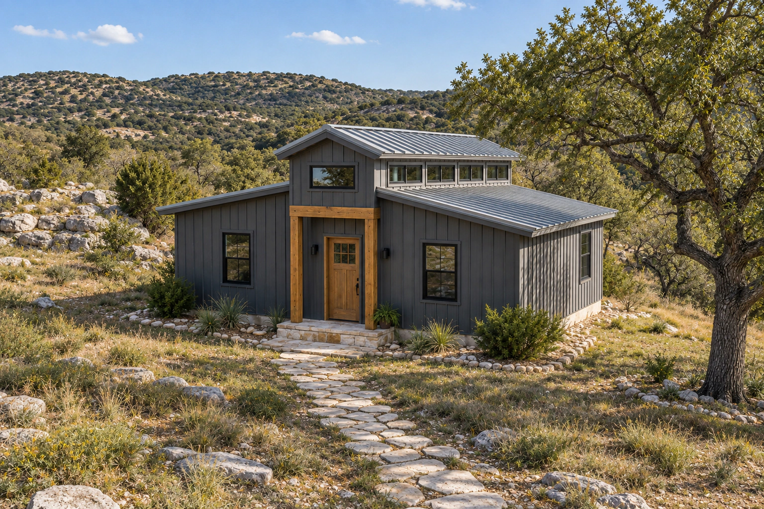 Compact monitor-style tiny barndominium with a raised central gable and lower side roofs in the Texas Hill Country